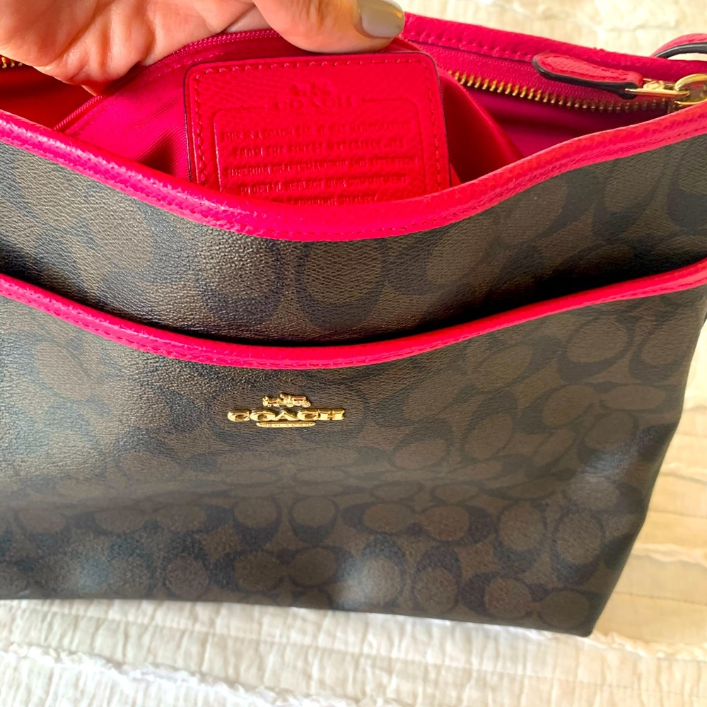 Brown Coach bag with dark pink trim.
